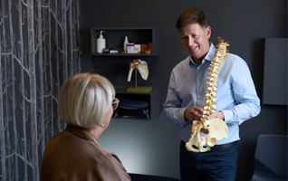 Physiotherapist advising a patient on bone health care
